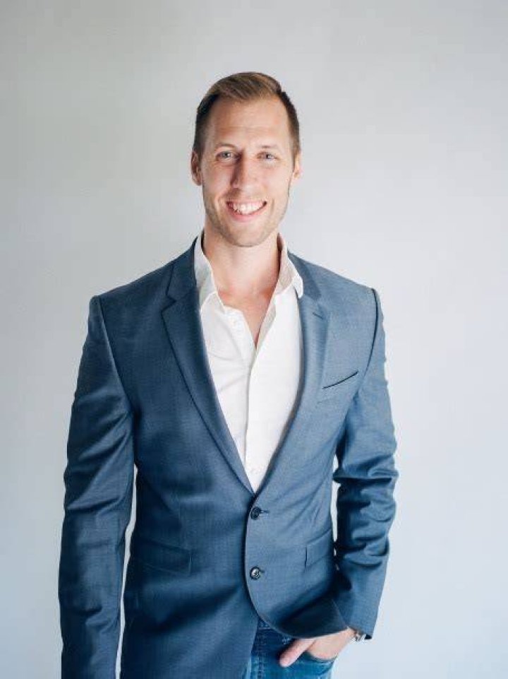 Andy Maurer posing for a photo shoot by putting his left hand inside his pocket.
