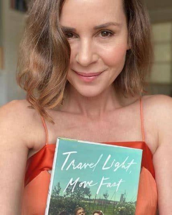Davidtz showing with her favorite book Travel Light Move Fast