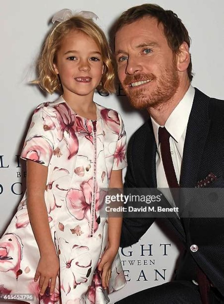 Florence Clery smiling in a pink floral print dress.