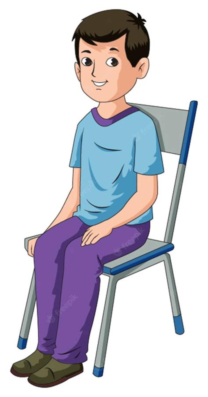 He is sitting in a chair alongside other people.