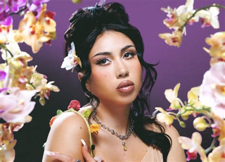 Kali Uchis sunbathing in a pool