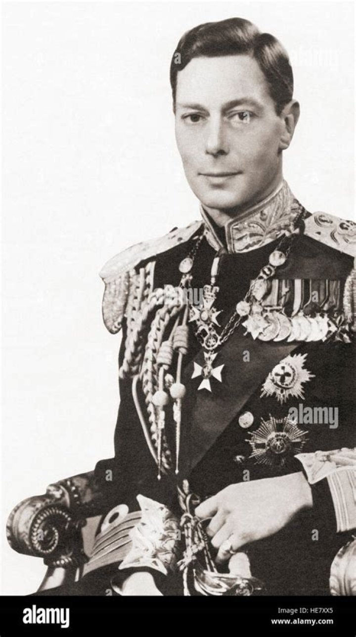King George VI (1895 - 1952) with Prince Charles on his third birthday.