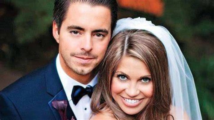 Tim Belusko is wearing a shirt, tie, and specs whereas, Danielle Fishel is wearing a white jacket.