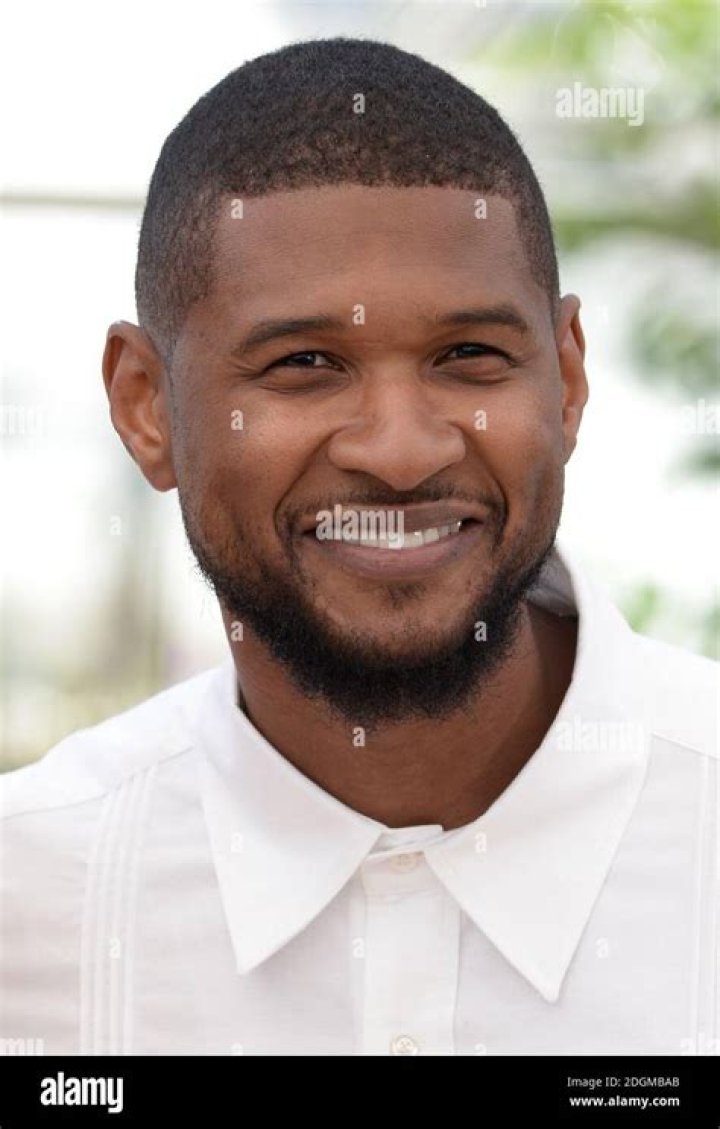 Usher Raymond IV posing in a black jacket, pants and goggles.